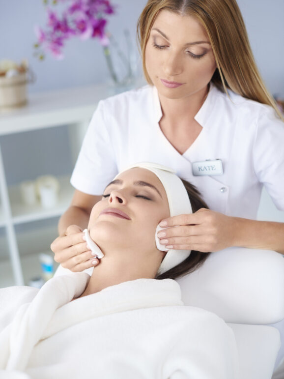Beautiful woman doing facial her client