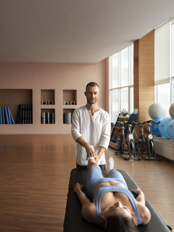 patient-doing-physical-rehabilitation-helped-by-therapists